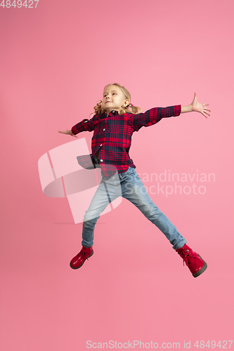 Image of Caucasian little girl\'s portrait on pink studio background