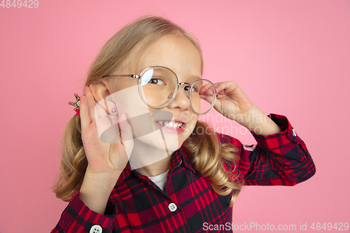 Image of Caucasian little girl\'s portrait on pink studio background