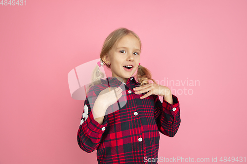 Image of Caucasian little girl\'s portrait on pink studio background