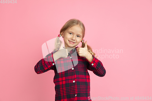 Image of Caucasian little girl\'s portrait on pink studio background