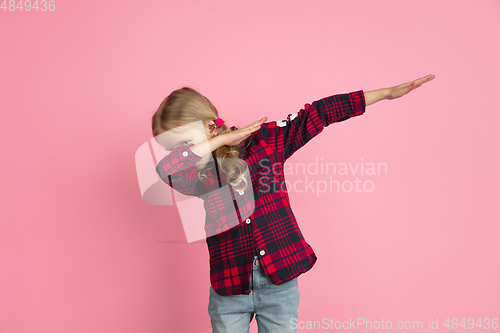 Image of Caucasian little girl\'s portrait on pink studio background