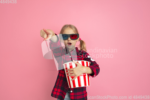 Image of Caucasian little girl\'s portrait on pink studio background, cinema concept