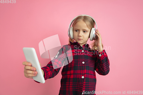 Image of Caucasian little girl\'s portrait on pink studio background