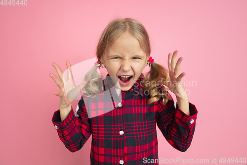 Image of Caucasian little girl\'s portrait on pink studio background