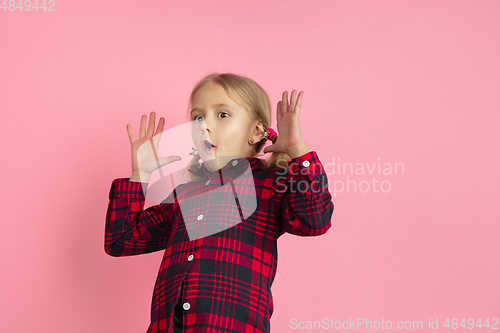 Image of Caucasian little girl\'s portrait on pink studio background
