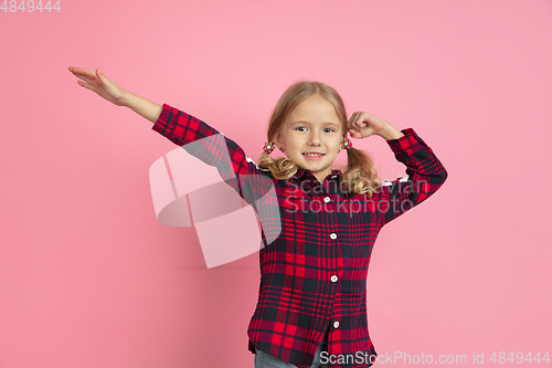 Image of Caucasian little girl\'s portrait on pink studio background