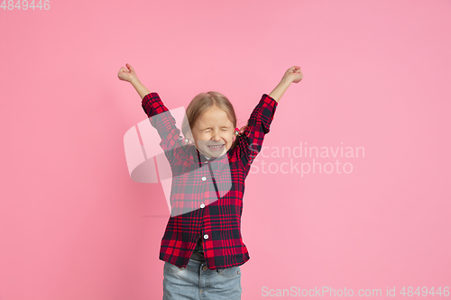 Image of Caucasian little girl\'s portrait on pink studio background