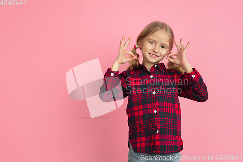 Image of Caucasian little girl\'s portrait on pink studio background