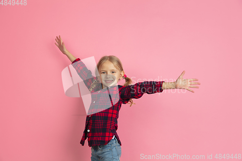 Image of Caucasian little girl\'s portrait on pink studio background