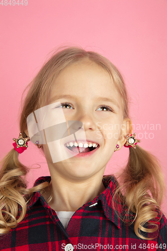 Image of Caucasian little girl\'s close up portrait on pink studio background