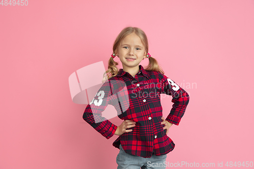 Image of Caucasian little girl\'s portrait on pink studio background