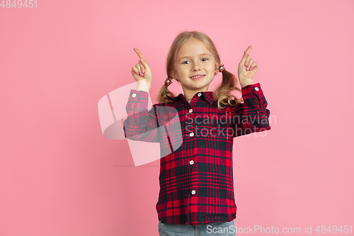 Image of Caucasian little girl\'s portrait on pink studio background