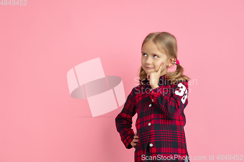 Image of Caucasian little girl\'s portrait on pink studio background