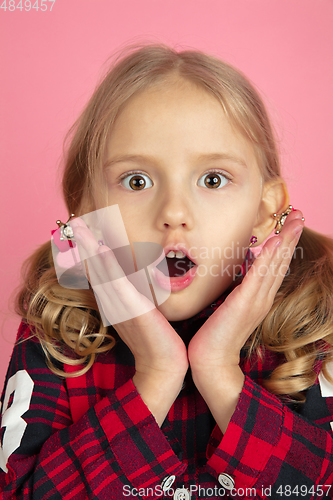 Image of Caucasian little girl\'s close up portrait on pink studio background