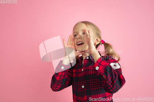 Image of Caucasian little girl\'s portrait on pink studio background