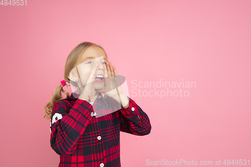 Image of Caucasian little girl\'s portrait on pink studio background