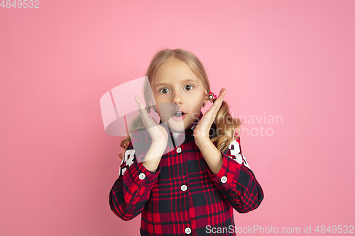 Image of Caucasian little girl\'s portrait on pink studio background