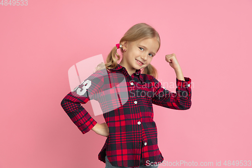 Image of Caucasian little girl\'s portrait on pink studio background