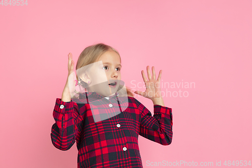 Image of Caucasian little girl\'s portrait on pink studio background