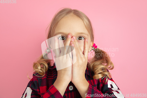 Image of Caucasian little girl\'s portrait on pink studio background