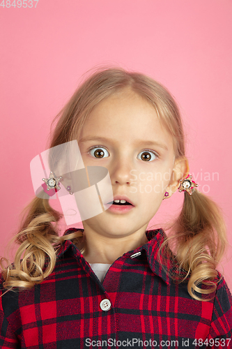 Image of Caucasian little girl\'s close up portrait on pink studio background