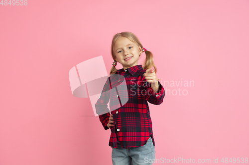 Image of Caucasian little girl\'s portrait on pink studio background