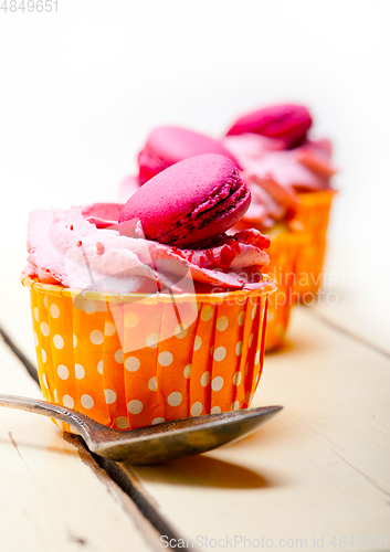 Image of pink berry cream cupcake with macaroon on top