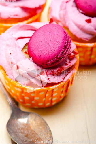 Image of pink berry cream cupcake with macaroon on top