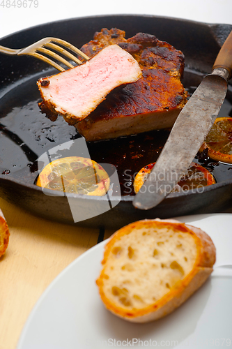 Image of pork chop seared on iron skillet