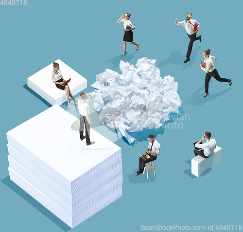 Image of High angle view of creative office on blue background - big things and little workers