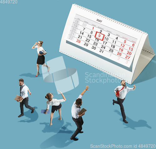 Image of High angle view of creative office on blue background - big things and little workers