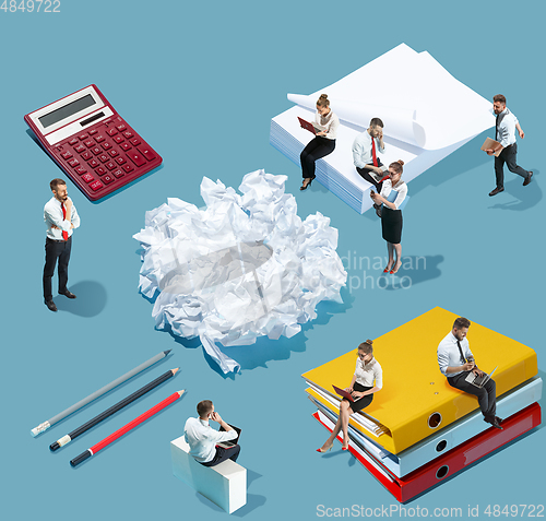 Image of High angle view of creative office on blue background - big things and little workers