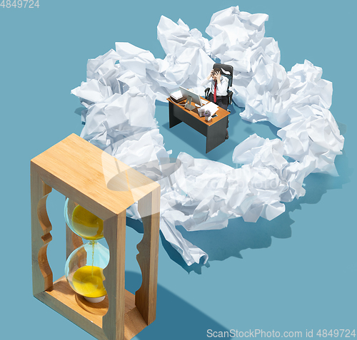 Image of High angle view of creative office on blue background - big things and little workers