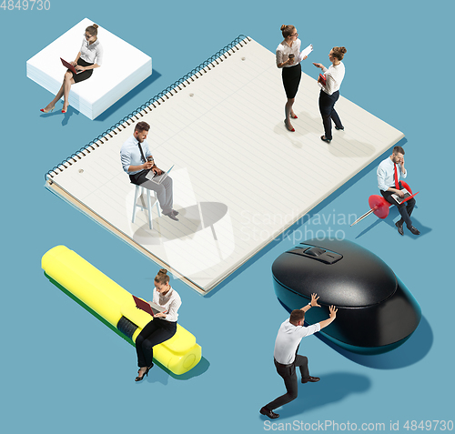 Image of High angle view of creative office on blue background - big things and little workers