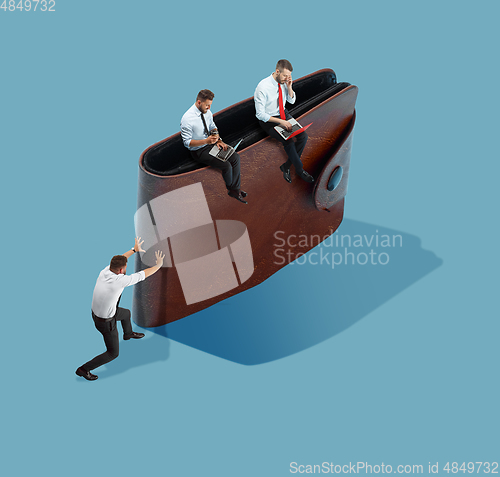 Image of High angle view of creative office on blue background - big things and little workers