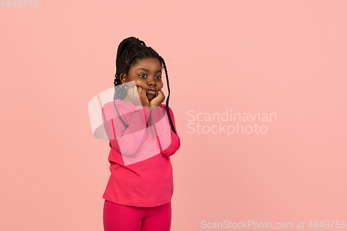 Image of Handsome african little girl portrait isolated on pink studio background with copyspace