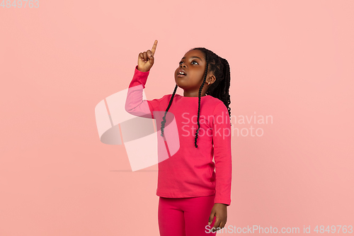 Image of Handsome african little girl portrait isolated on pink studio background with copyspace