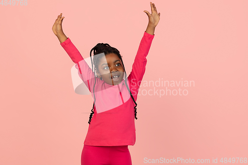 Image of Handsome african little girl portrait isolated on pink studio background with copyspace