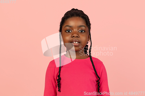 Image of Handsome african little girl portrait isolated on pink studio background with copyspace