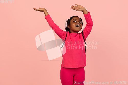 Image of Handsome african little girl portrait isolated on pink studio background with copyspace