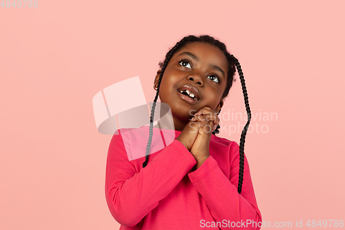 Image of Handsome african little girl portrait isolated on pink studio background with copyspace