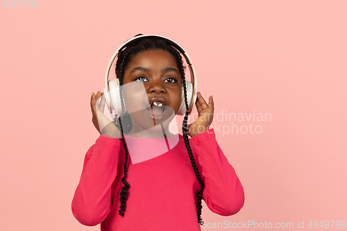 Image of Handsome african little girl portrait isolated on pink studio background with copyspace