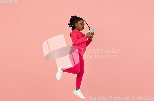 Image of Handsome african little girl portrait isolated on pink studio background with copyspace