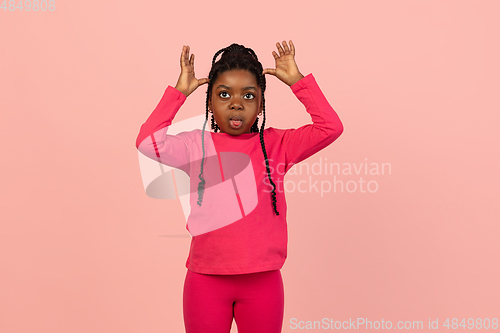 Image of Handsome african little girl portrait isolated on pink studio background with copyspace