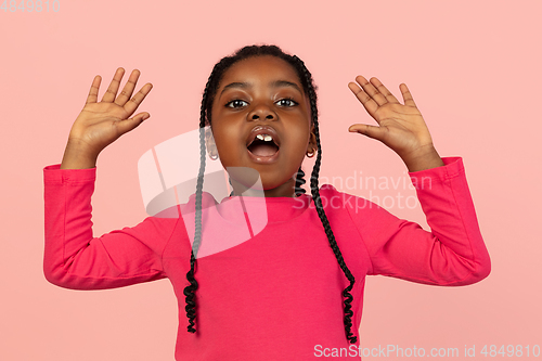 Image of Handsome african little girl portrait isolated on pink studio background with copyspace