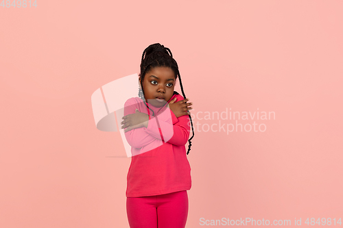 Image of Handsome african little girl portrait isolated on pink studio background with copyspace