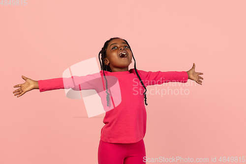 Image of Handsome african little girl portrait isolated on pink studio background with copyspace