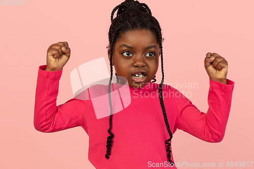 Image of Handsome african little girl portrait isolated on pink studio background with copyspace