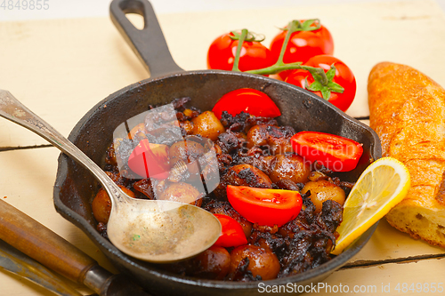 Image of Baby cuttle fish roasted on iron skillet