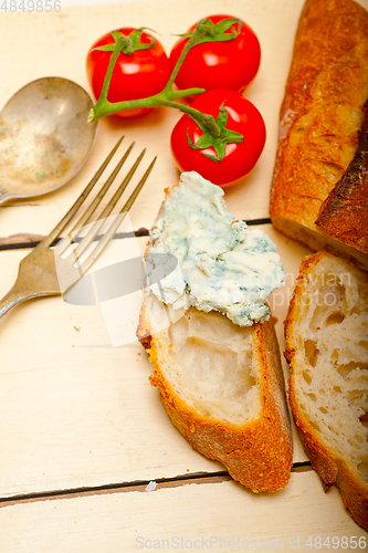 Image of fresh blue cheese spread ove french baguette